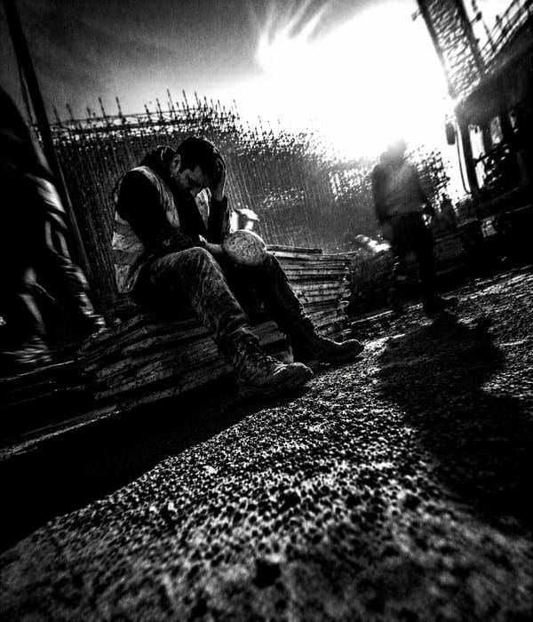 Construction worker wearing ear defenders — tinnitus and noise-induced hearing damage on UK building sites